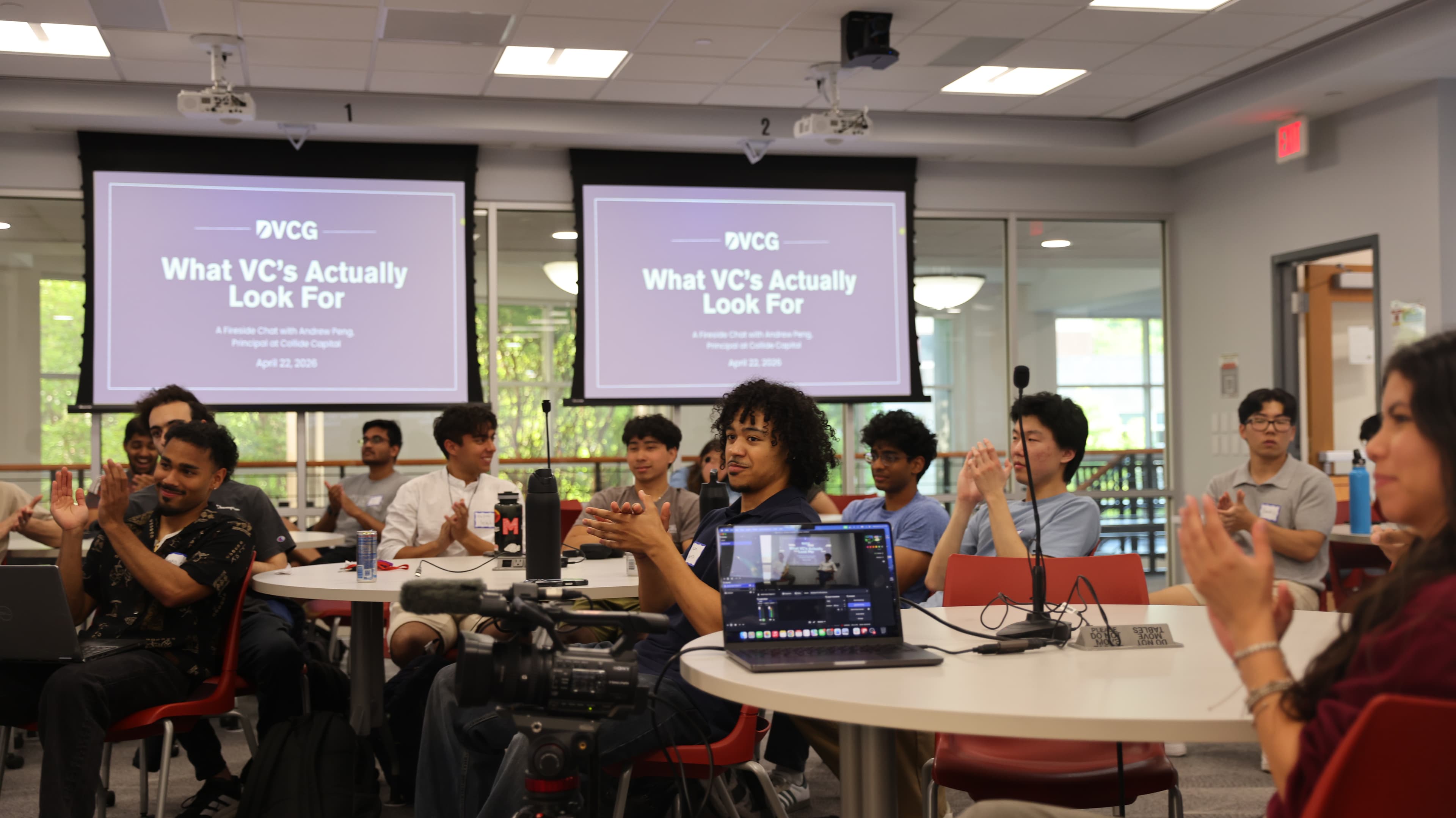A DVCG session in progress, a slide reading What VCs Actually Look For on the screens