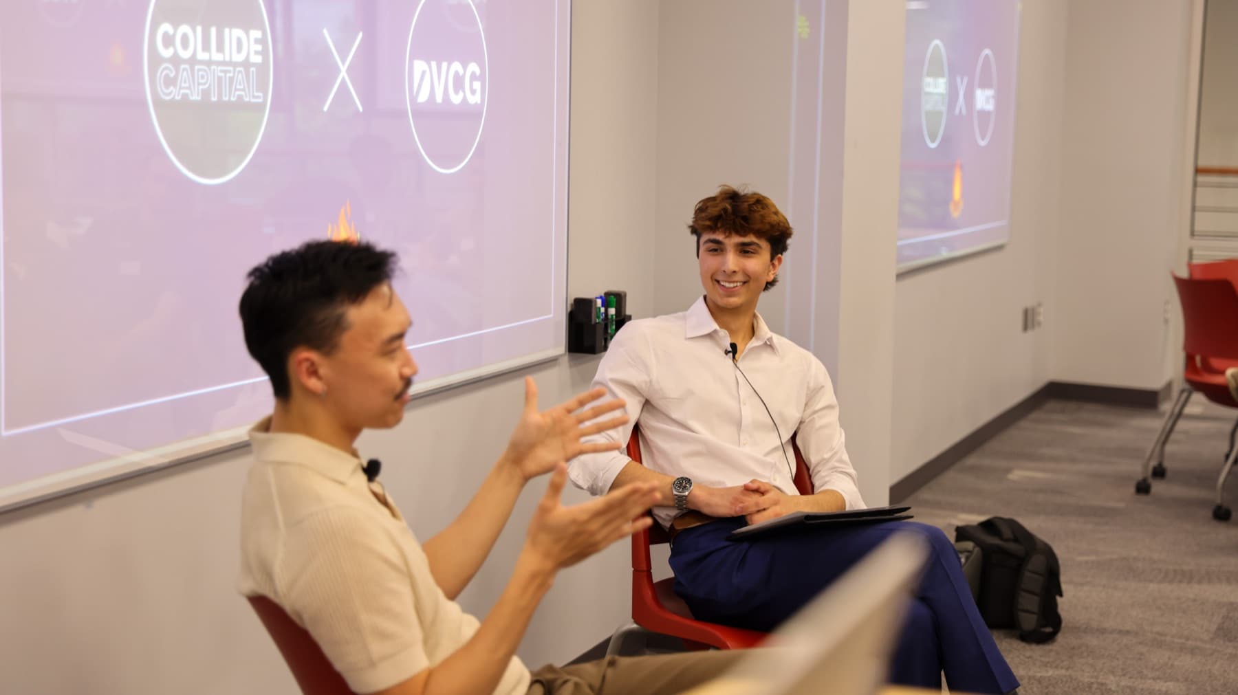 A DVCG member in conversation with an investor at the Collide Capital session, both mic'd