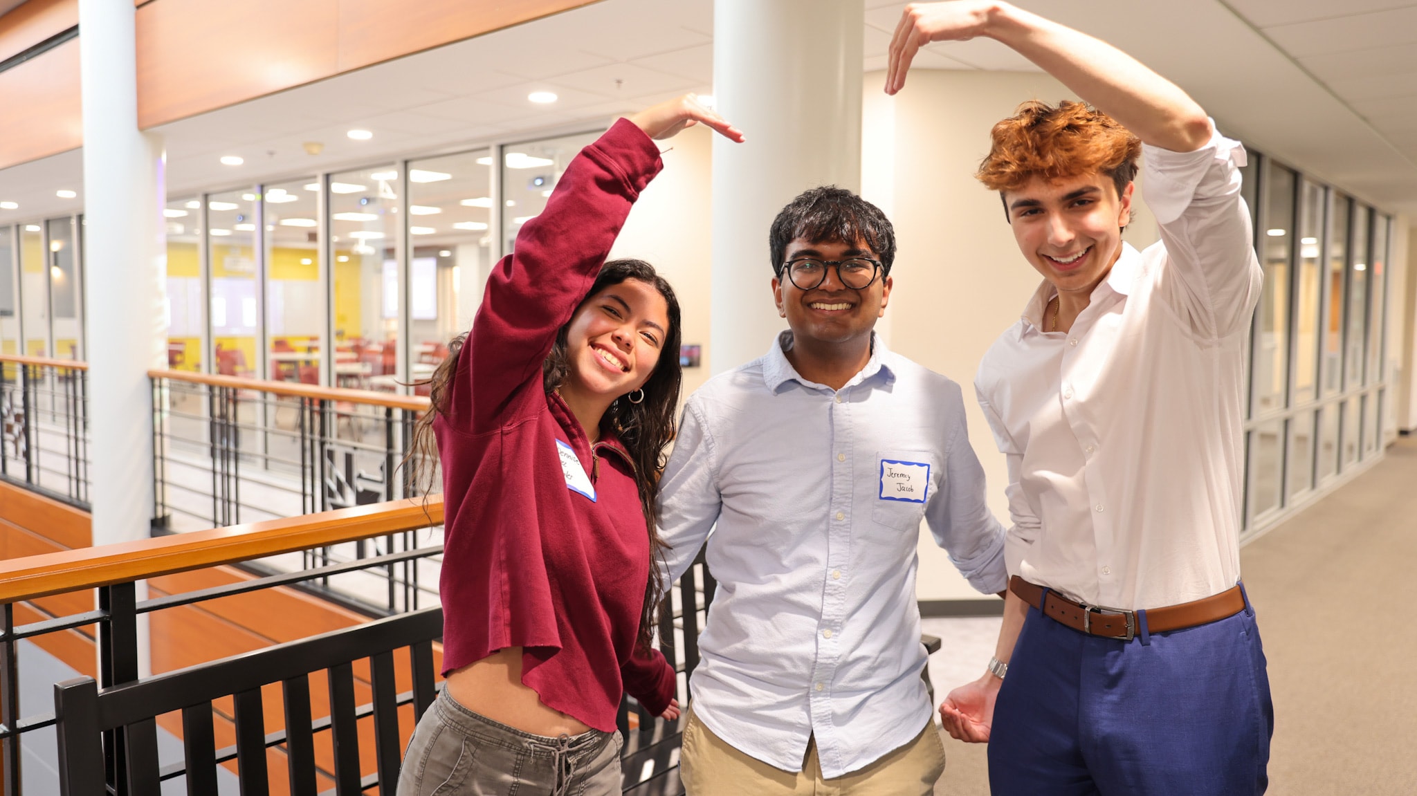 Three DVCG members with their arms raised, laughing